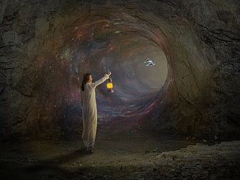 Woman holding lantern in cave with galaxy wormhole and spaceship