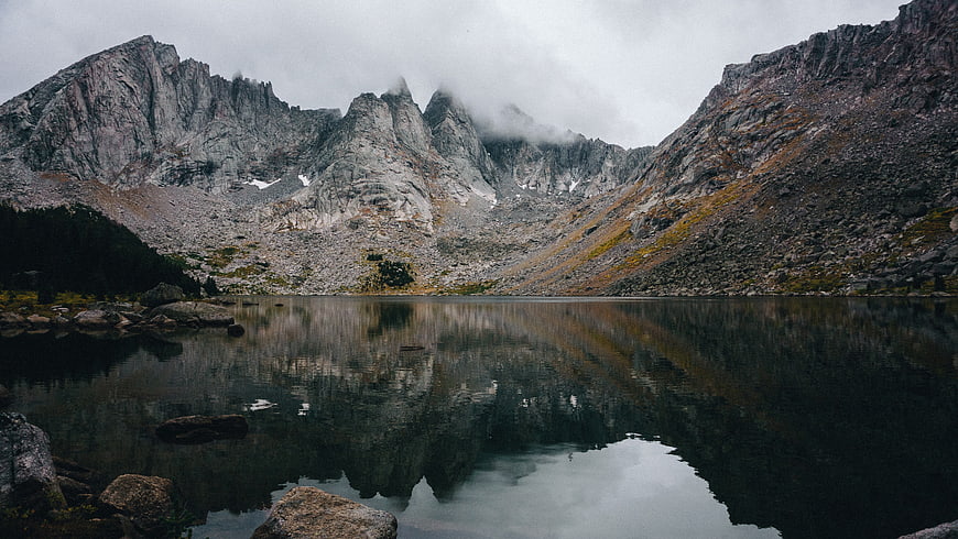 Misty Mountain Peaks Reflected in Alpine Lake