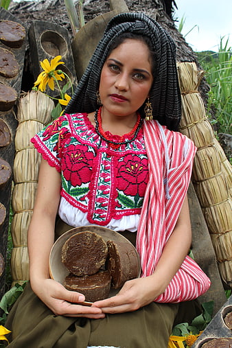 Indigenous Mexican Woman in Traditional Oaxacan Clothing Holding Panela