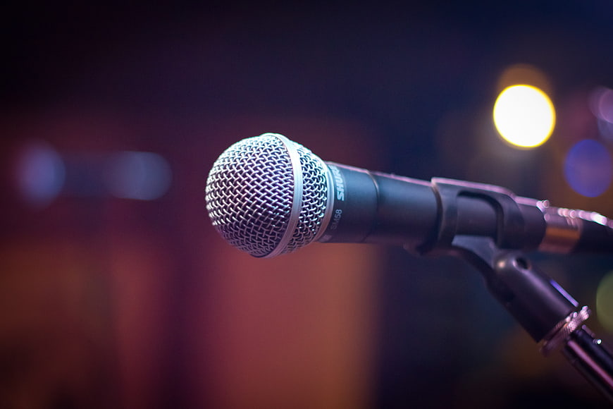 Close-up of microphone on stand with bokeh background