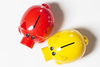 Red and Yellow Piggy Banks on White Background