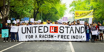 Protesters holding United We Stand for a Racism-Free India banner