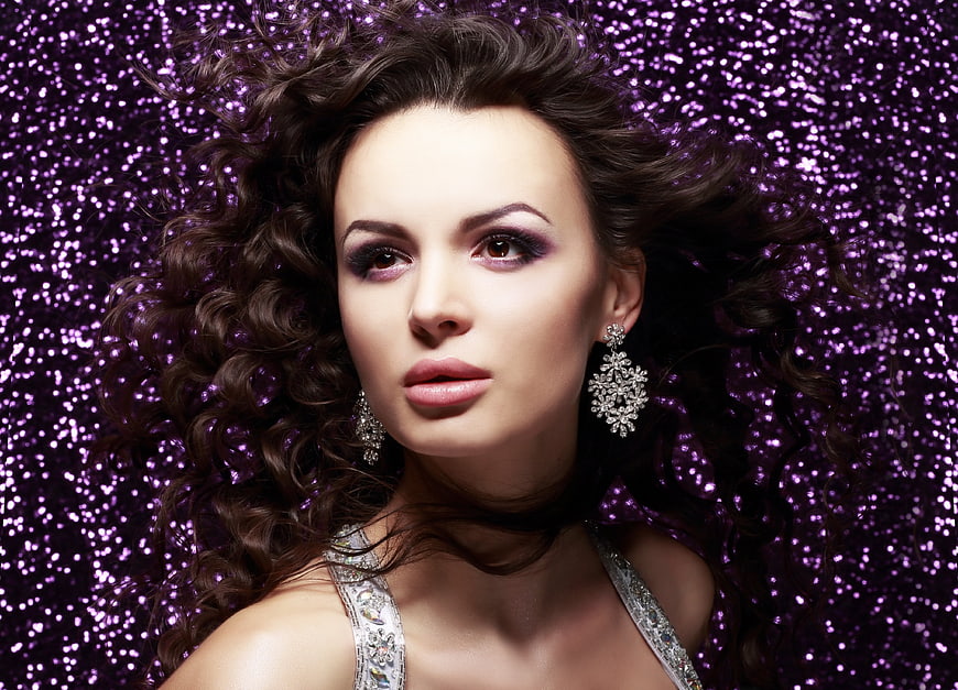 Glamorous Woman Portrait with Purple Glitter Background