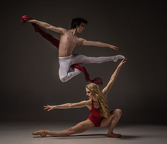 Male and female ballet dancers performing dynamic contemporary dance poses
