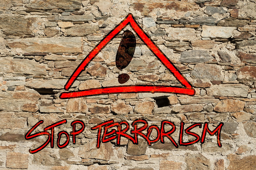 Stop Terrorism Graffiti Warning Sign On Old Stone Wall