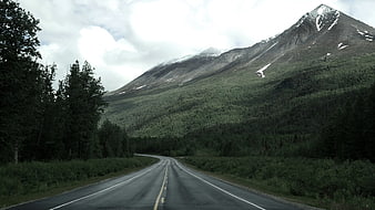 Winding Mountain Road Through Forested Valley