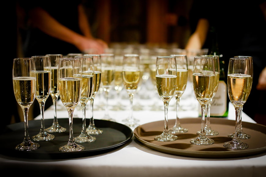 Champagne flutes on serving trays for a celebration