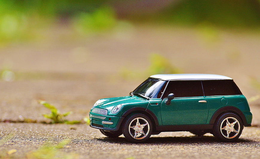 Green Mini Cooper Toy Car on Pavement