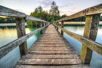 Wooden Pier Over Calm Lake at Sunset