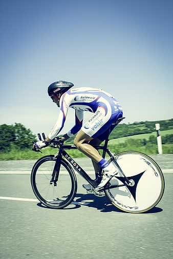 Professional Cyclist Racing on Road with Time Trial Bike