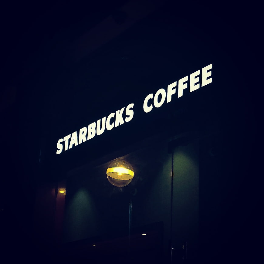 Illuminated Starbucks Coffee Sign at Night