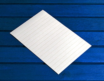 Blank Lined Paper Sheet on Blue Wooden Background