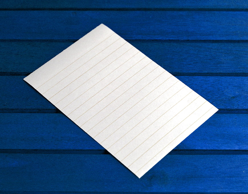 Blank Lined Paper Sheet on Blue Wooden Background