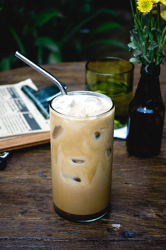 Iced Coffee Latte with Metal Straw on Wooden Table