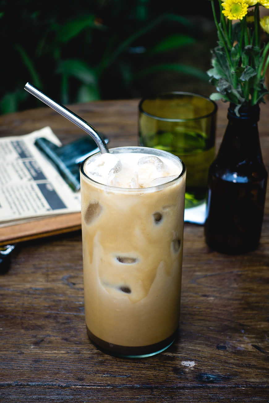 Iced Coffee Latte with Metal Straw on Wooden Table