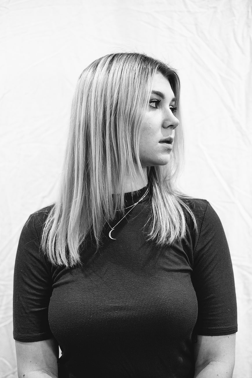 Black and white portrait of young woman looking away