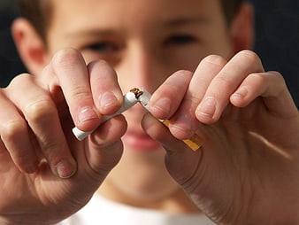 Young Man Breaking Cigarette In Half