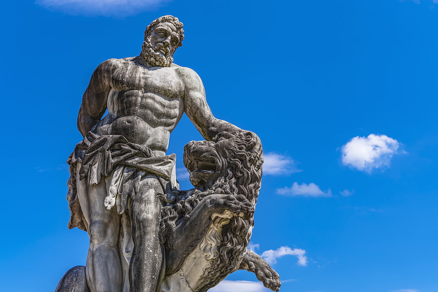 Hercules Statue with Lion Skin Against Blue Sky