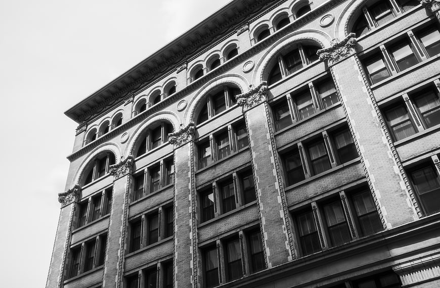 Black and White Low Angle View of Historic Brick Building Facade