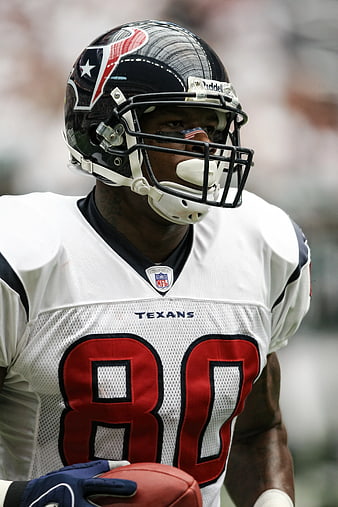 American Football Player in White Texans Jersey Holding Ball