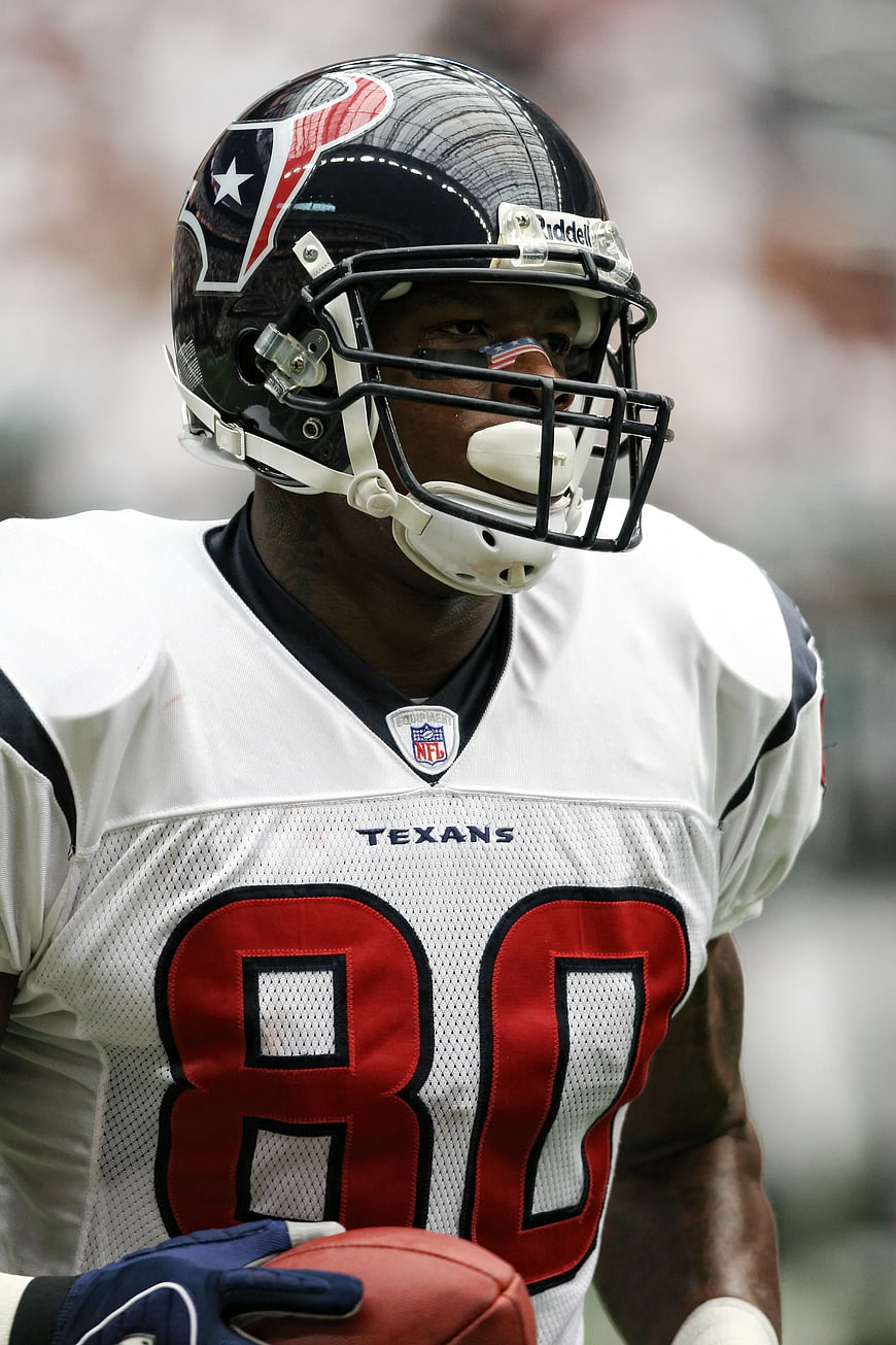 American Football Player in White Texans Jersey Holding Ball