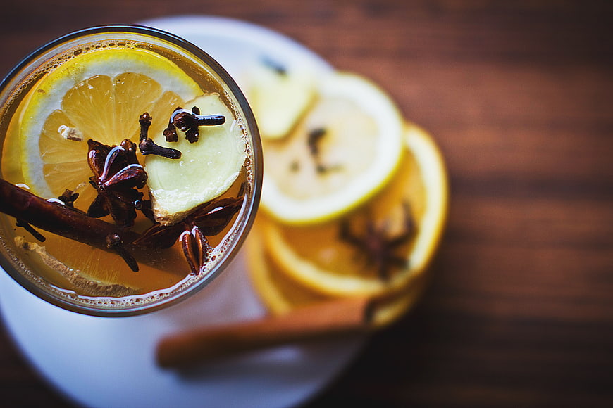 Overhead view of hot spiced cider with lemon and cinnamon