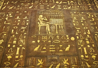 Ancient Egyptian Hieroglyphs and Carvings on Stone Wall