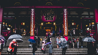 Crowds with umbrellas at Senso-ji Temple entrance in Tokyo