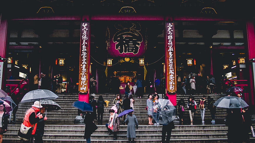Crowds with umbrellas at Senso-ji Temple entrance in Tokyo