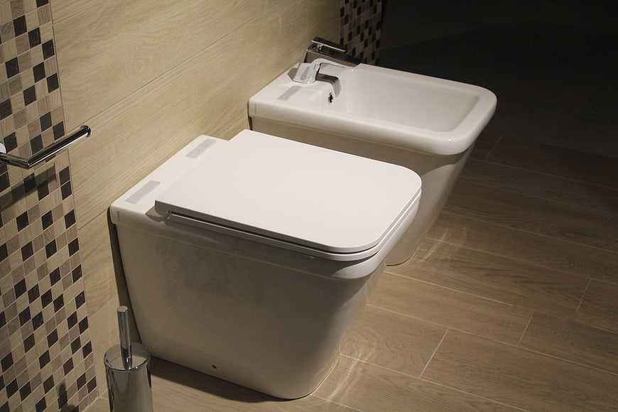 Modern White Ceramic Toilet And Bidet In Contemporary Bathroom