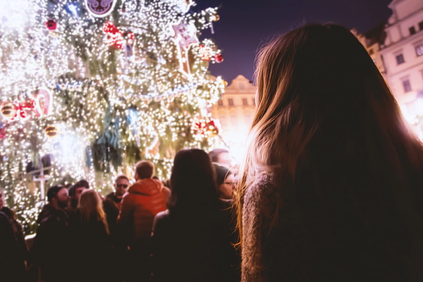 Woman Viewing Christmas Tree Lights at Night Market