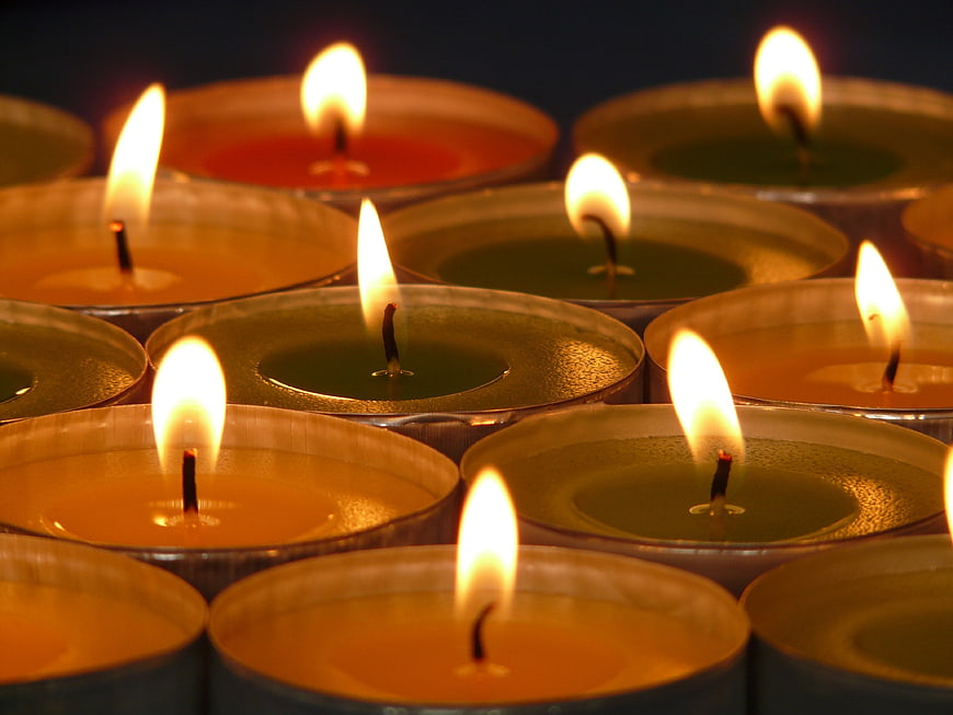Close-up of burning tea light candles with warm flames