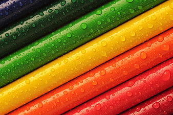 Vibrant Rainbow Pencils with Water Droplets Close-Up