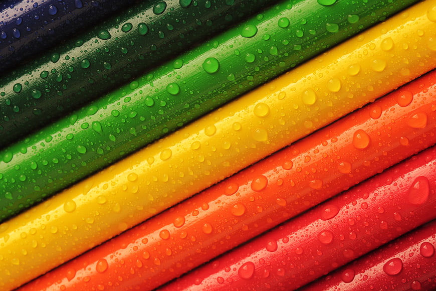 Vibrant Rainbow Pencils with Water Droplets Close-Up