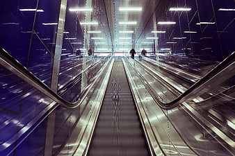 Modern Metro Station Escalator With Blue Reflections And Urban Architecture