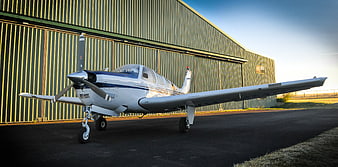 Small Private Propeller Airplane Parked In Front Of Hangar