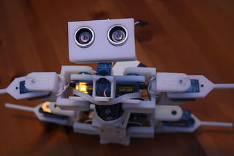 Close-up of white DIY robot with ultrasonic sensors