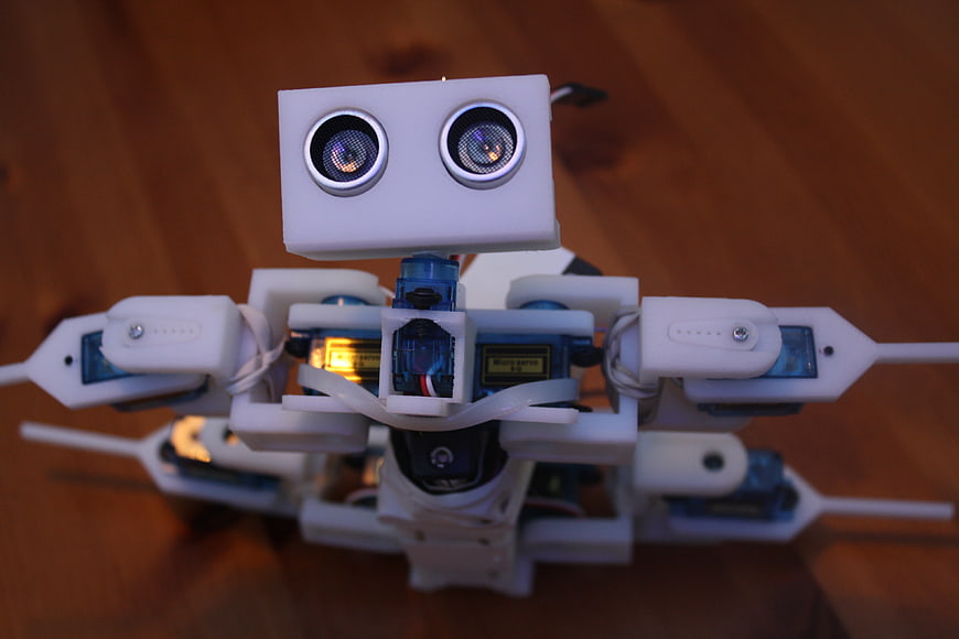 Close-up of white DIY robot with ultrasonic sensors