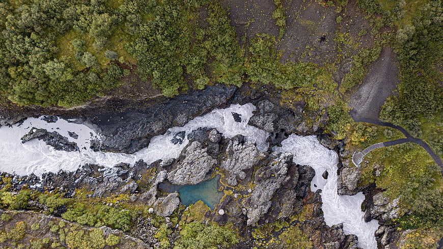 Aerial View of Turbulent River and Waterfall in Iceland