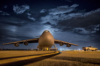 Low angle night shot of military cargo plane on tarmac