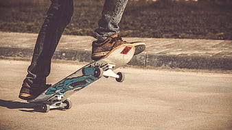 Skateboarder performing a trick on a sunny street