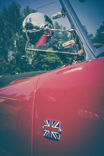 Close-up of red vintage car with Union Jack badge