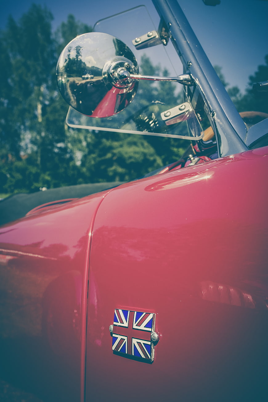 Close-up of red vintage car with Union Jack badge