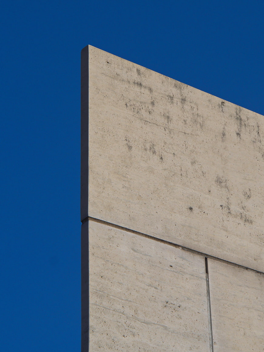 Minimalist concrete building corner against blue sky