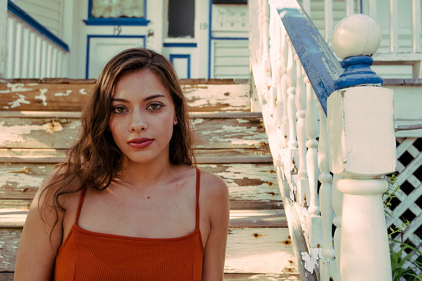 Young Brunette Woman Portrait on Weathered Wooden Porch Steps