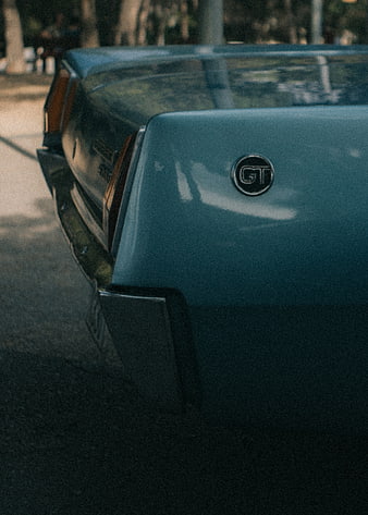 Close-up of vintage blue classic car rear with GT emblem