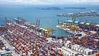 Aerial View of Busy Container Port with Cargo Ships and Cranes
