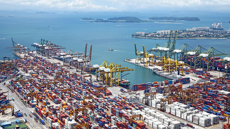 Aerial View of Busy Container Port with Cargo Ships and Cranes