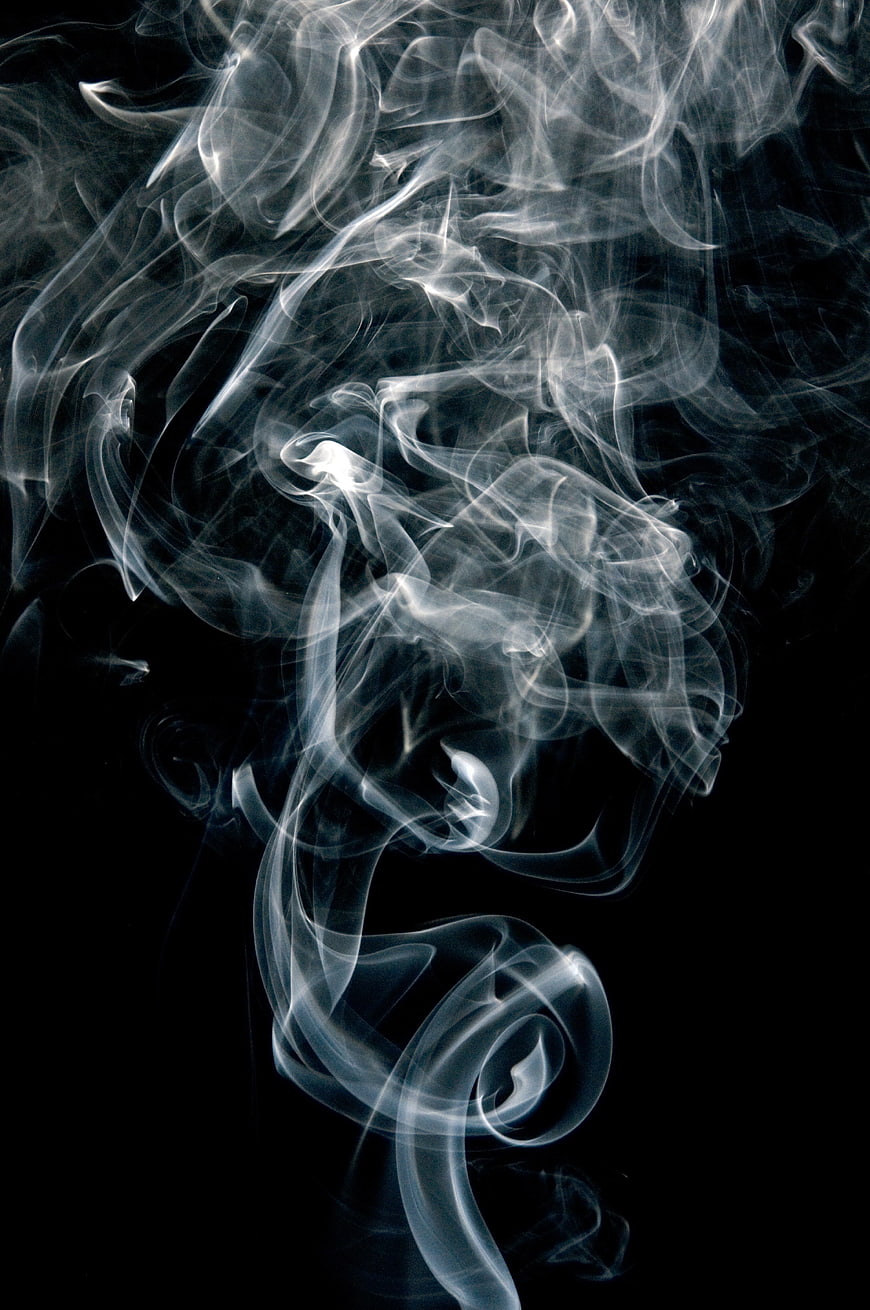 Abstract White Smoke Swirls on Black Background