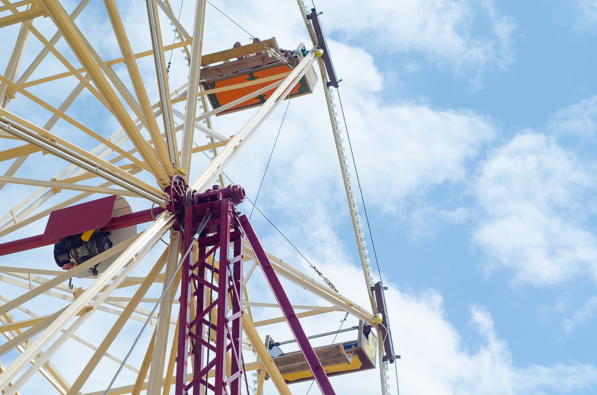 Vintage Ferris Wheel Structure Against Blue Sky